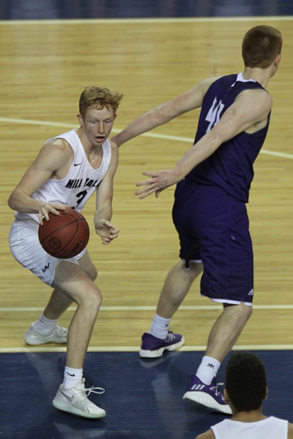 After grabbing an offensive rebound, senior Sammy Rebeck dribbles away from his defender to find an open teammate.
