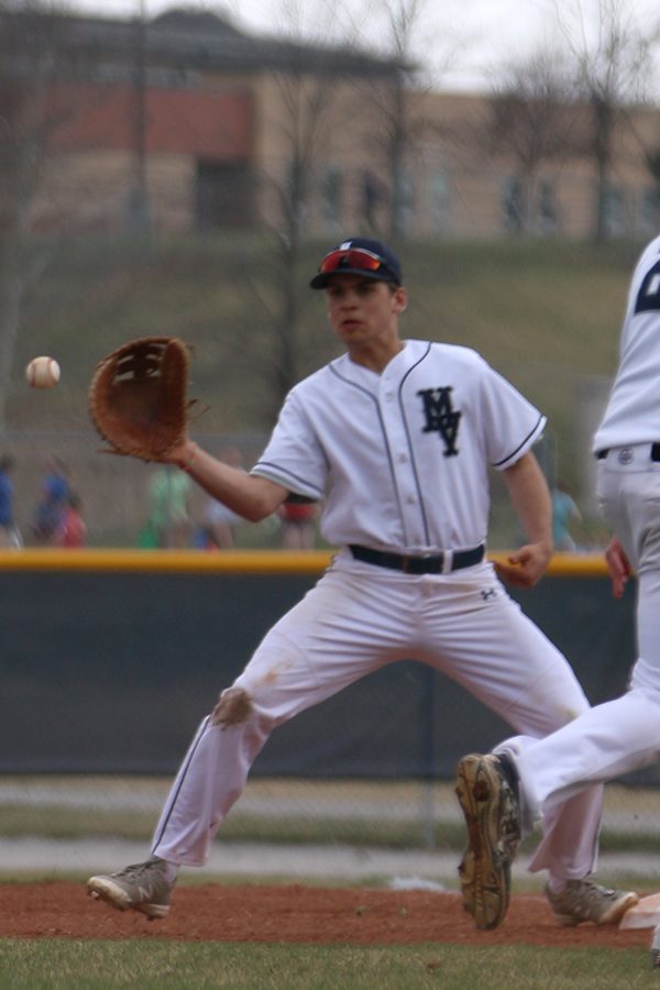 Senior Jack Correll looks to catch a ball thrown from the pitcher to get the batter out. 