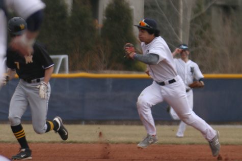 Running down his opponent, junior Johnathan Contreras gets an out. The Jaguars beat Shawnee Mission West 4-1 on Friday, March 23. 