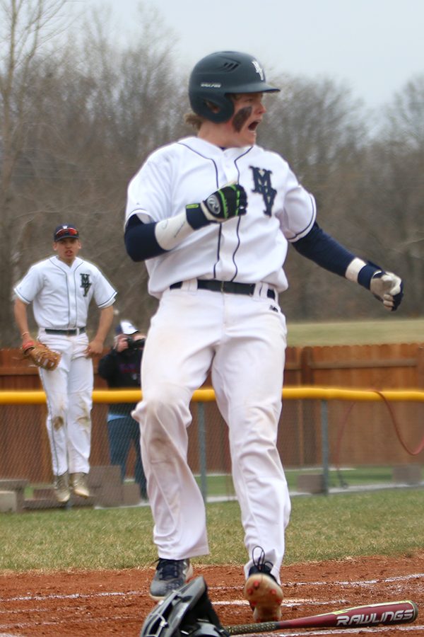 With a hit from junior Ethan Keopke, junior Cole Moore runs from second base to score the first run for the Jaguars. 