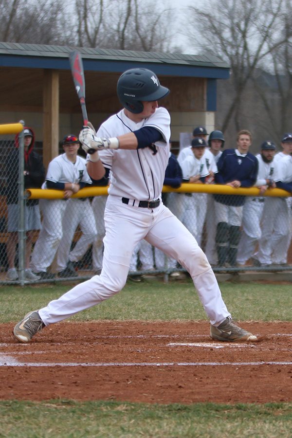 Stepping toward the pitcher, junior Ethan Judd prepares to swing the bat. 