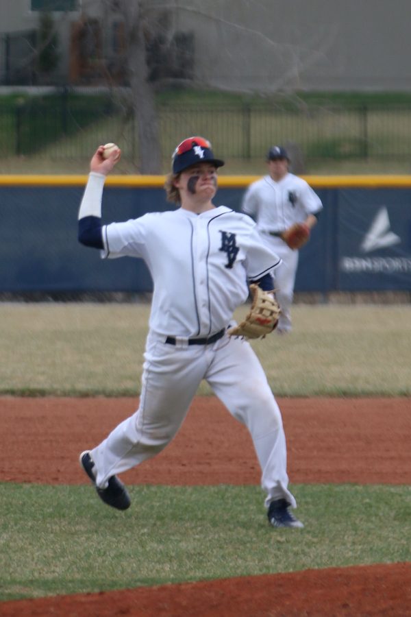 After fielding the ball, junior Cole Moore, throws it to first baseman Jack Correll to record an out. 