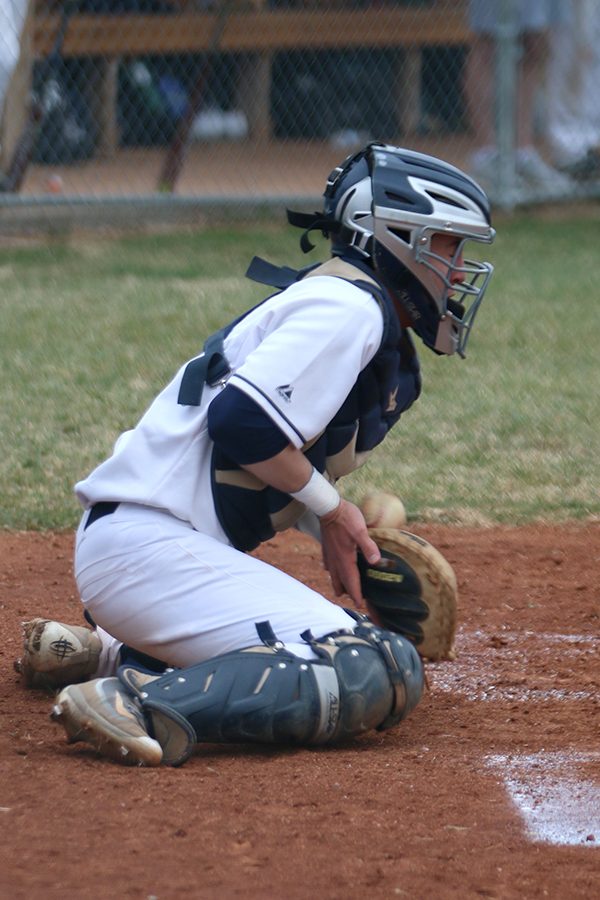 With an opponent on third base, junior Ethan Judd works to keep the ball in front of him. 