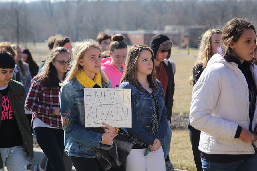 Holding her sign up, sophomore Callie Roberts walks back to class after the demonstration.