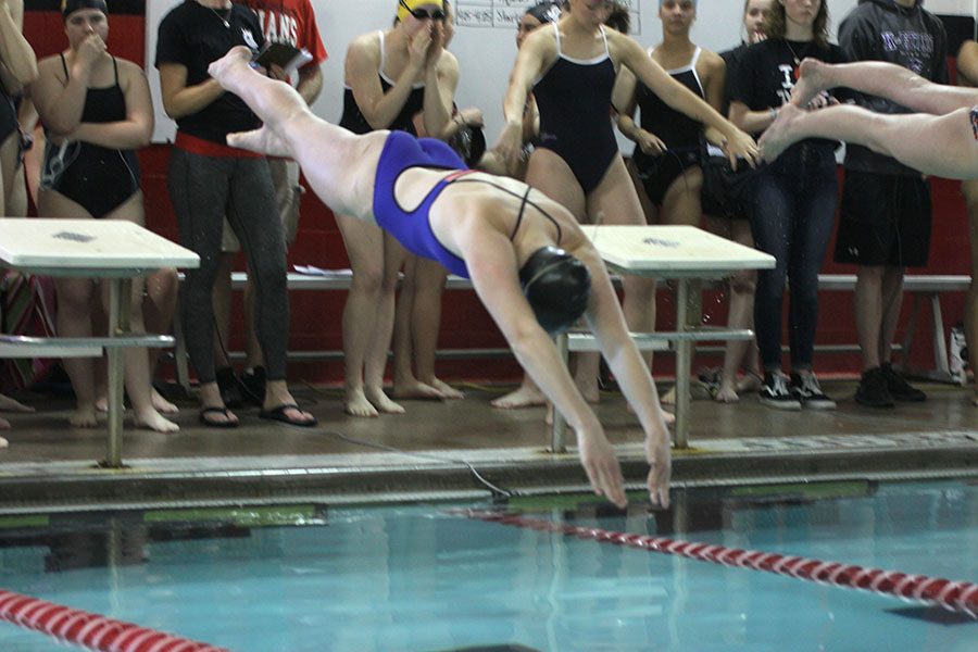 Sophomore Kayla Teasley dives into the water.