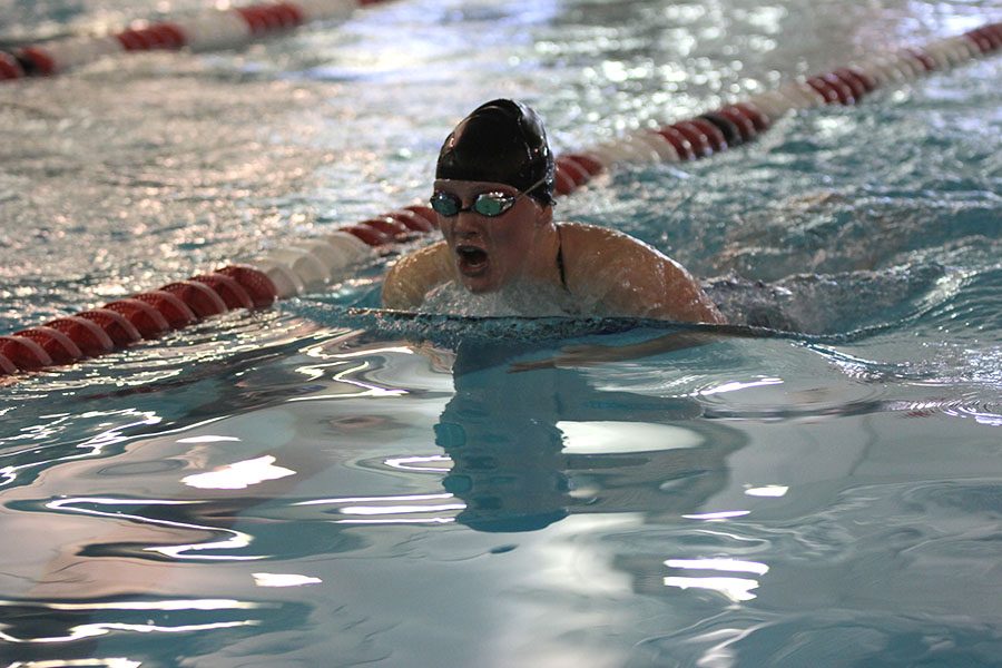 Sophomore Kayla Teasley takes a breath while swimming breast stroke.