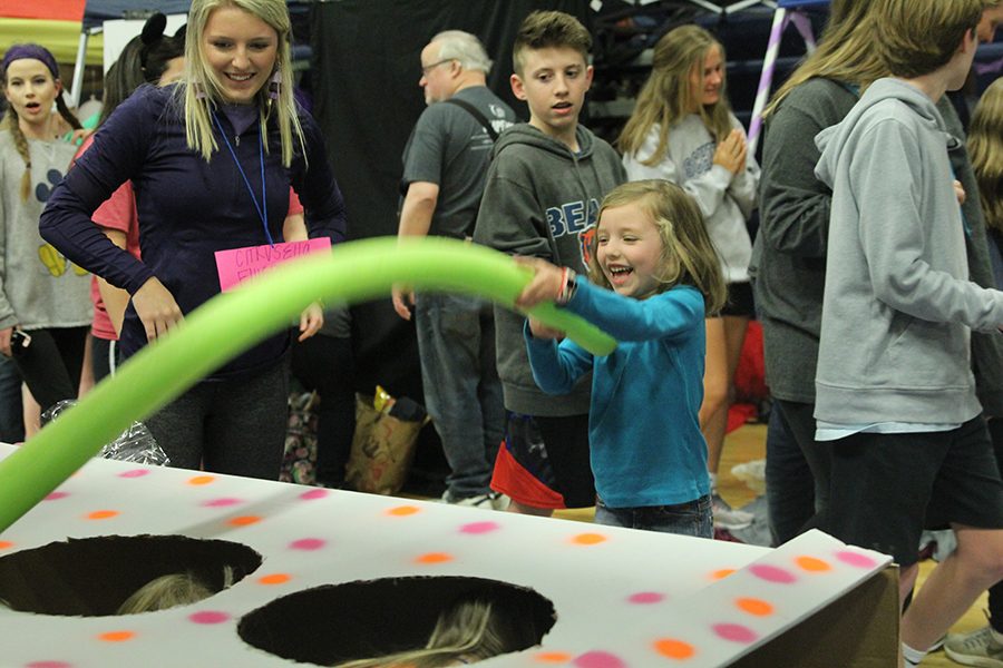 A member of the community plays an onsite fundraising game.