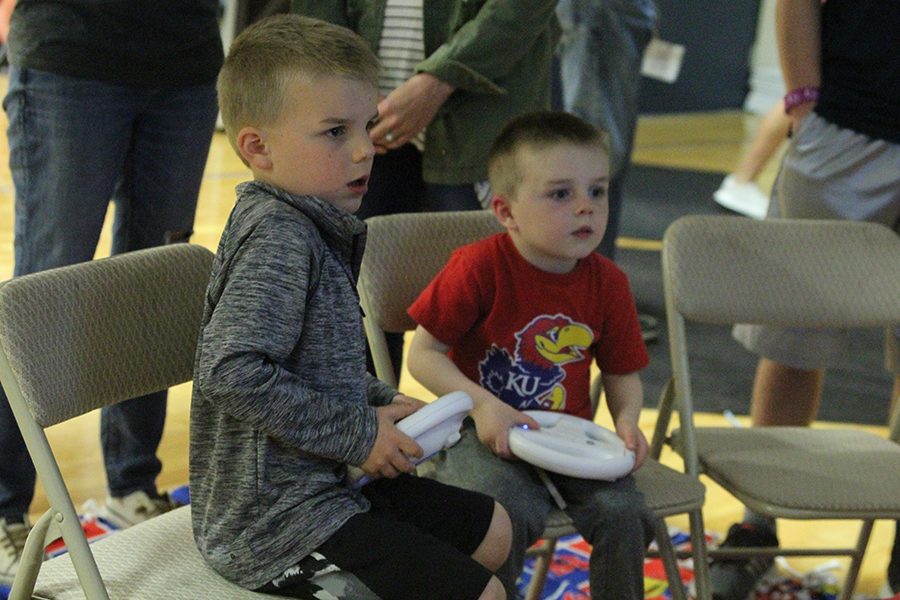 Members of the community play "Mario Kart" at an on-site fundraiser.