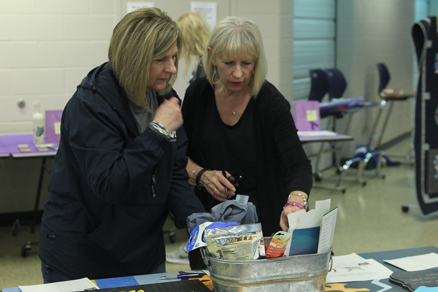 Members of the community look at items available at the silent auction.