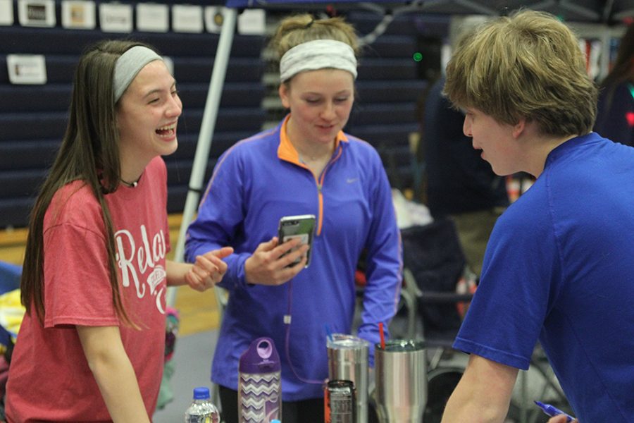 Freshman Katherine Weigel smiles while working her onsite fundraiser with junior Ally Appl. 