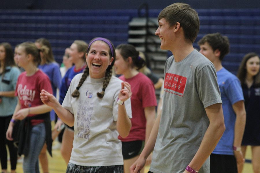Senior Gracie Eckardt smiles at junior Blake Aerni after finishing a dance routine in Zumba. 
