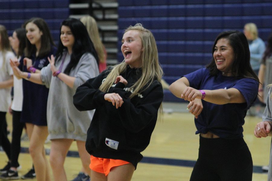 Junior Olivia Loftin dances with junior Mya Johnston during Zumba. 