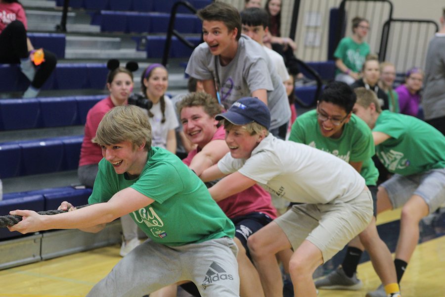 Sophomore Andrew Tow and junior Jakob Twigg participate in tug of war with other students at the event.