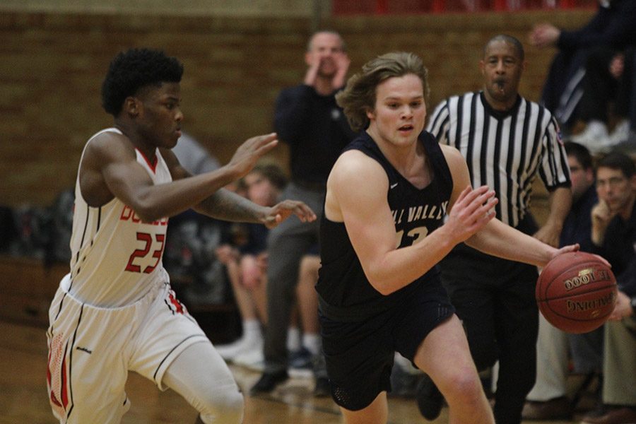 Senior Cooper Kaifes drives past a defender.