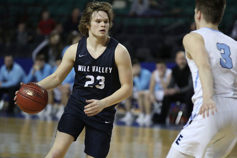 During the second half, senior Cooper Kaifes dribbles in front of a defender.