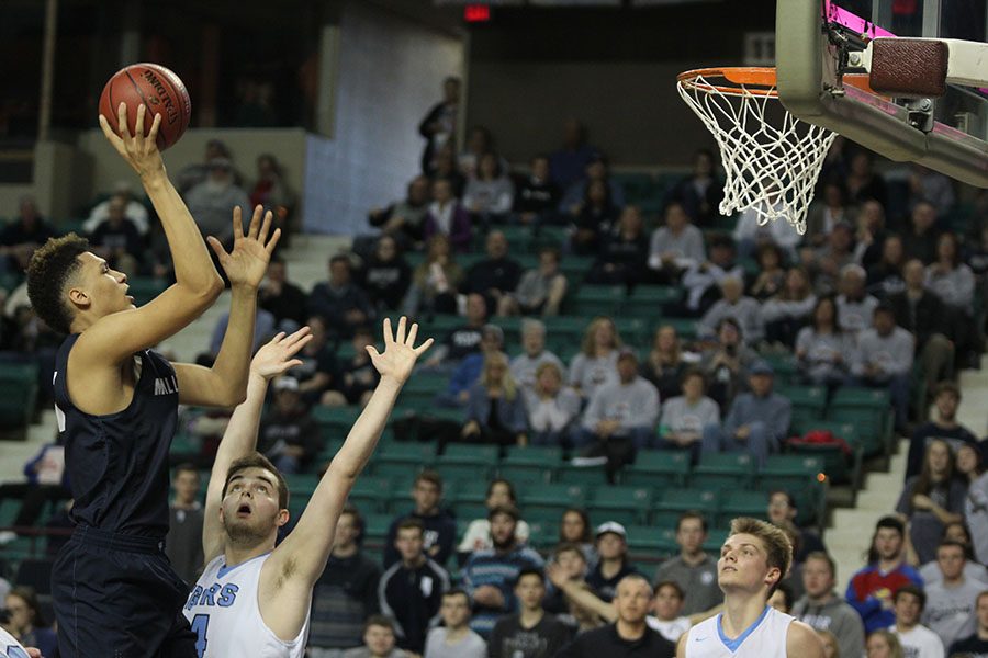 Freshman Keeshawn Mason attempts to score a basket.