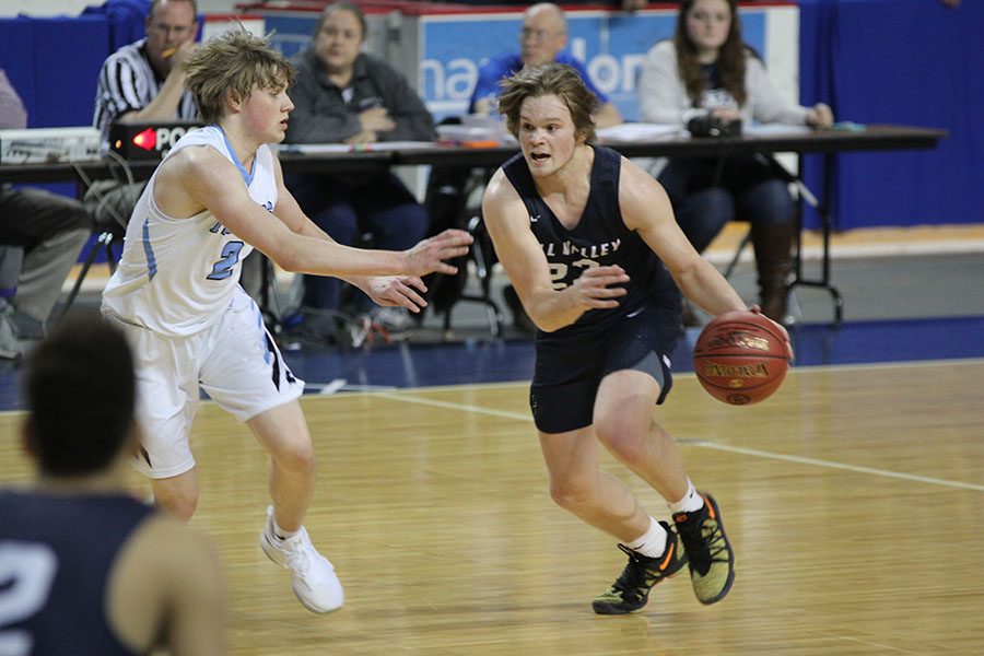 Senior Cooper Kaifes drives towards the basket.