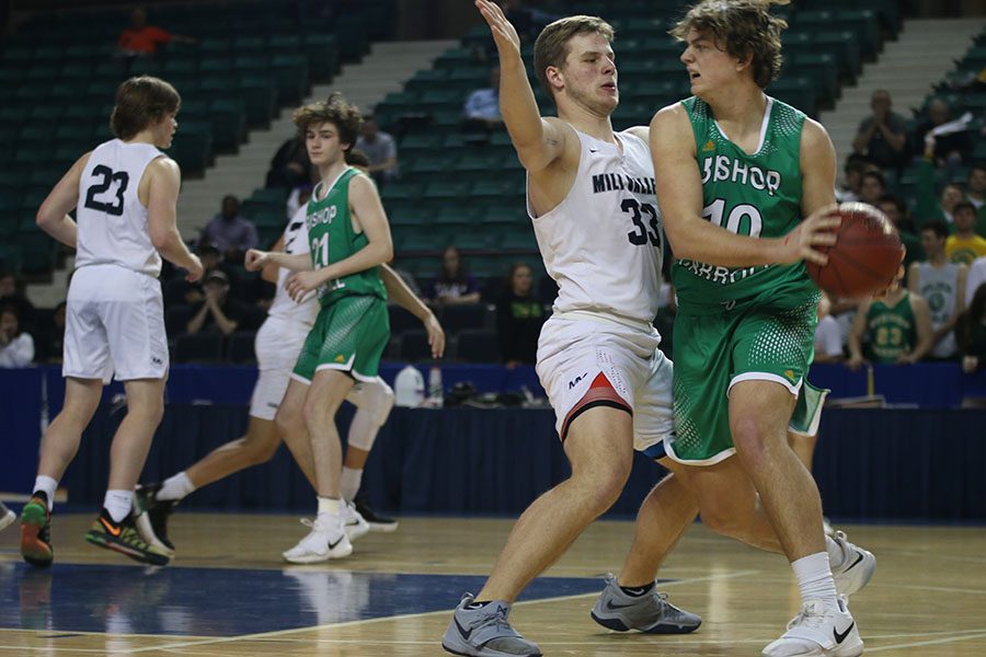 With his feet planted, senior Brody Flaming attempts to block an opponent from making a pass.