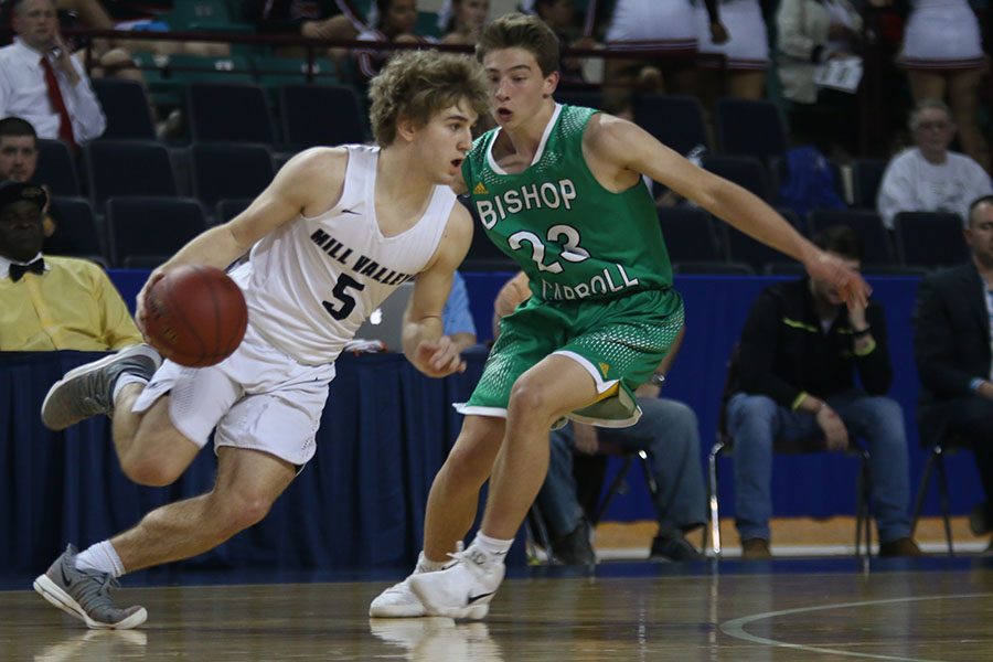 With his eyes on the goal, junior Logan Talley makes a break around a defender.