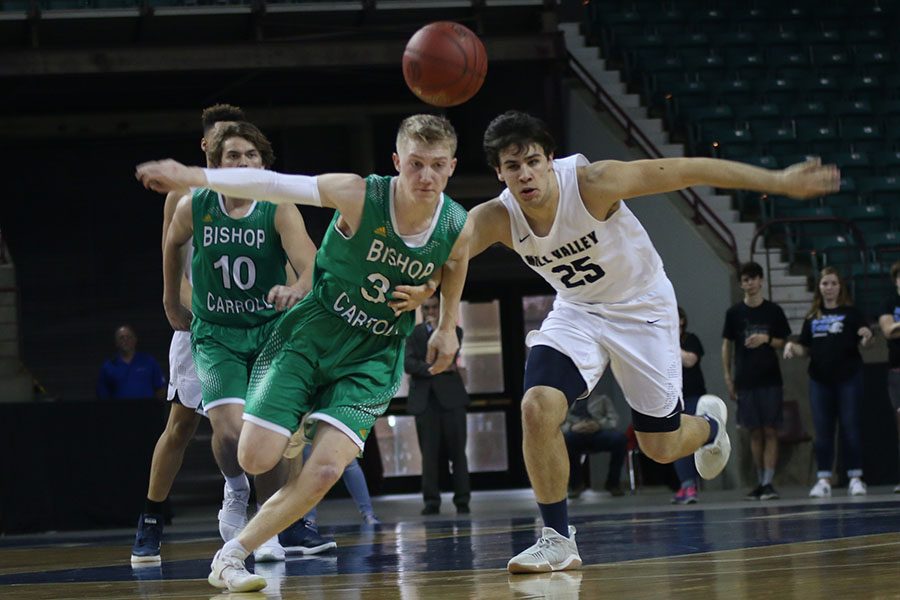 With an arm locked against his opponent, senior Ike Valencia races to get to the ball.