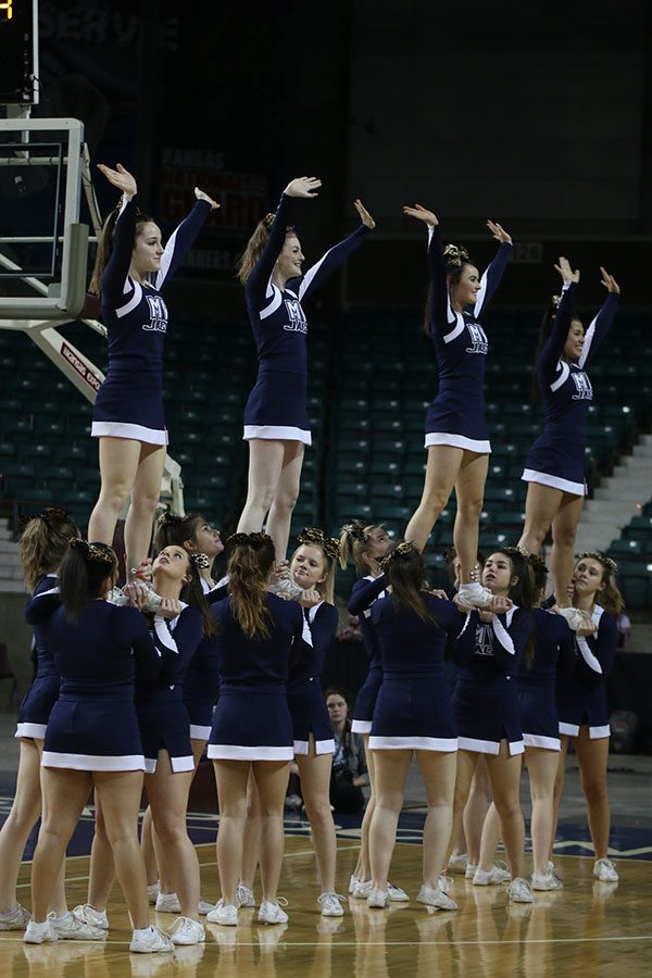 During a time-out, the cheerleaders perform a stunt to pump up the crowd.