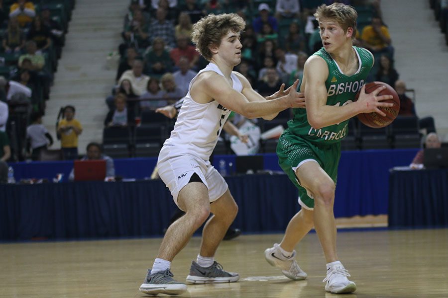 Attempting to draw a foul, junior Logan Talley defends an opponent.