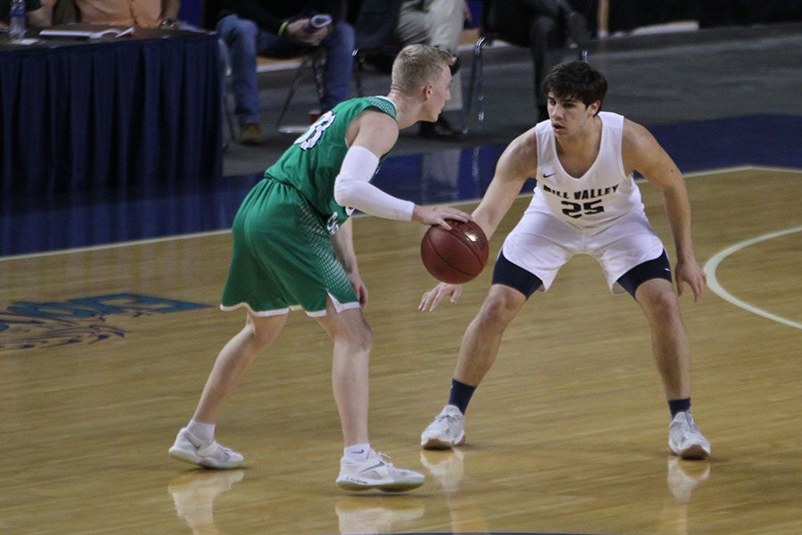 With his eyes locked on his opponent, senior Ike Valencia follows the Bishop-Carroll player.