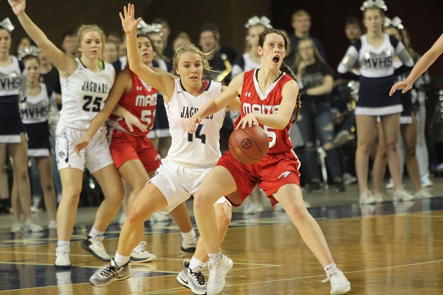 After rushing back on defense, senior Adde Hinkle closely guards a Maize player.
