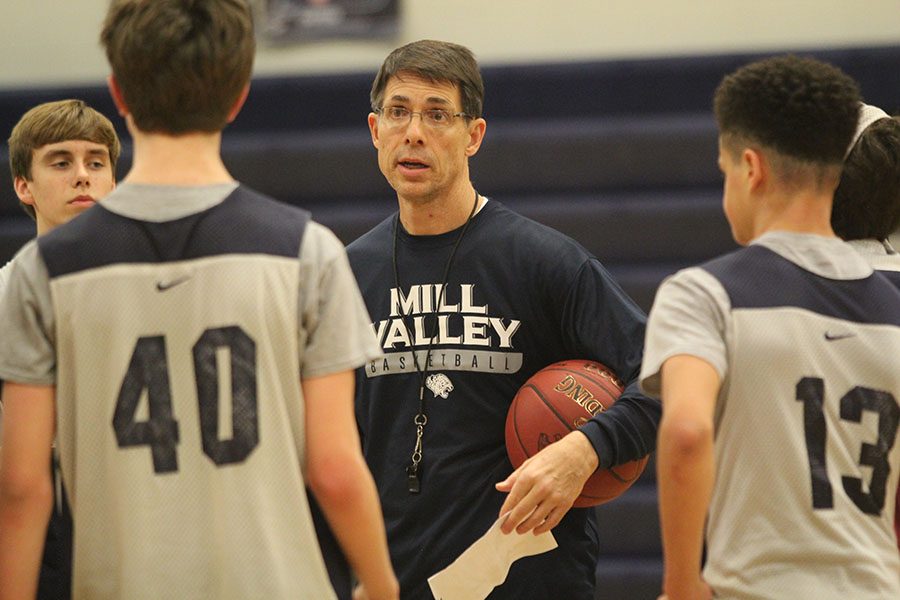 During practice on Friday, Feb. 23, sophomore basketball coach Steve Bock instructs the team on how to perform the next drill.