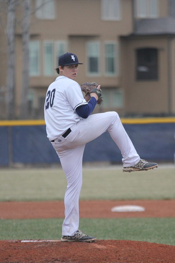 Looking towards home plate, junior Nolan Sprague prepares to throw a pitch. 