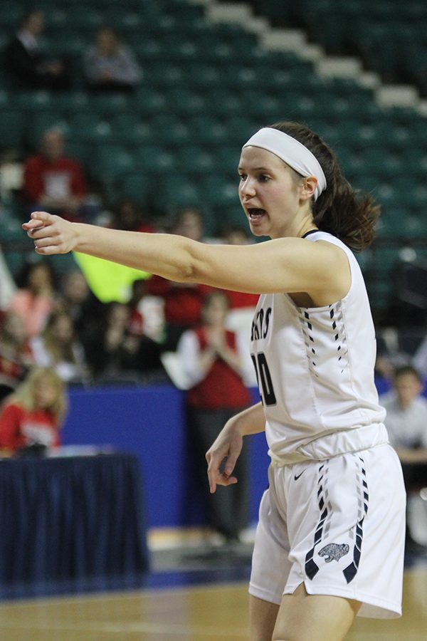 Looking to rebound the ball, junior Trinity Knapp directs teammates.
