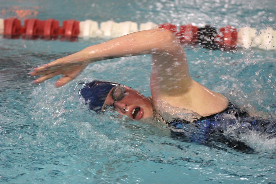 Junior Mia Thomas takes a breath between strokes while swimming the freestyle.