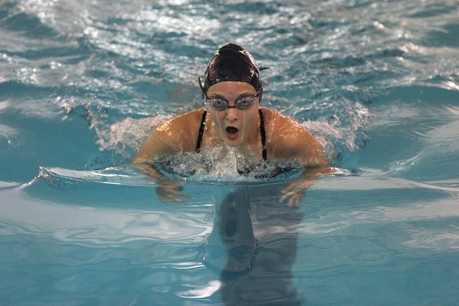 While swimming breast stroke , junior Sydney Walkup takes a breath in between strokes.