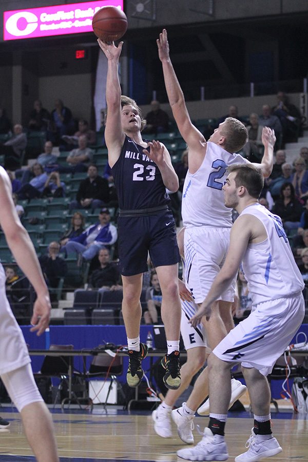 Just outside the lane, senior Cooper Kaifes pulls up to shoot a jump shot. 

