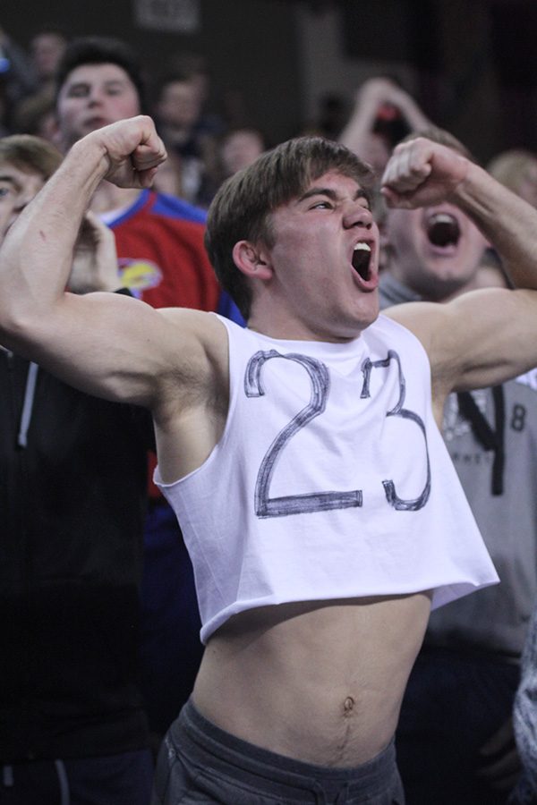 Senior Conner Ward flexes after senior Cooper Kaifes makes a three. 
