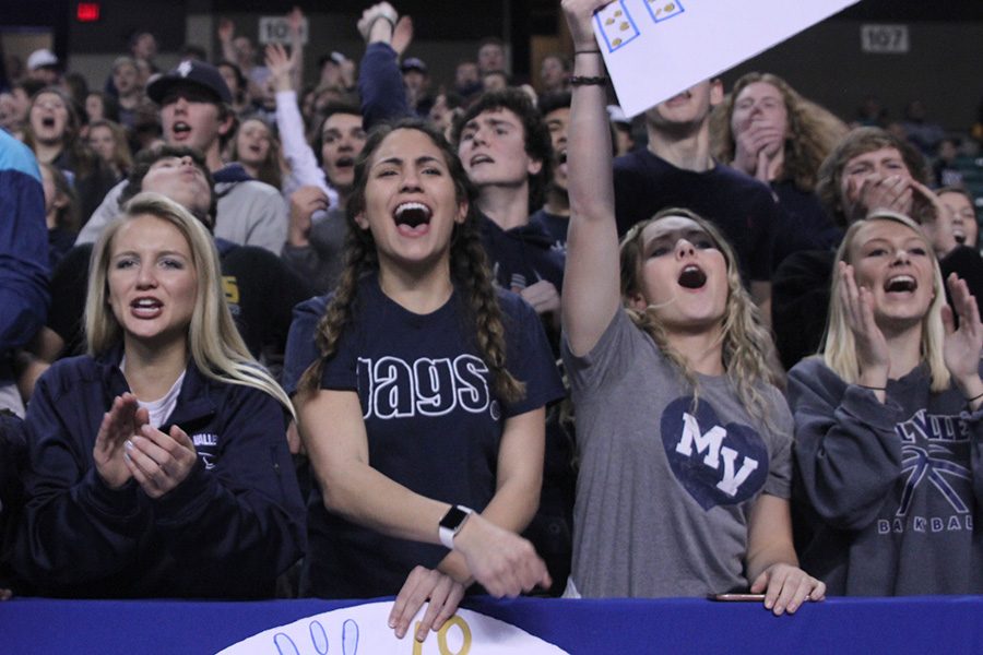 Closing out the third quarter, seniors Whitney Moylan, Allie Harvey, Emmy Bidnick and Taylar Powers cheer as the Jaguars increase their lead. 
