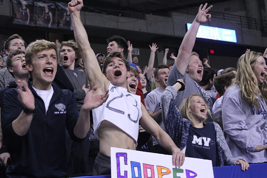 As a three point shot is made in the fourth quarter, seniors Carter Lawson and Conner Ward get excited. 

