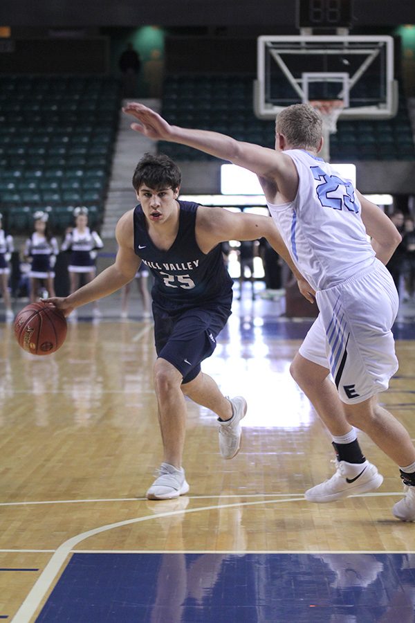 Senior Ike Valencia looks past his defender for an open path to the basket. 
