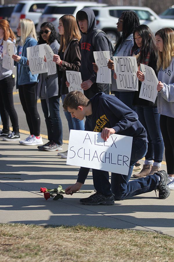 Honoring Parkland victim Alex Schachter, freshman Ben Wieland lays a rose in his name.