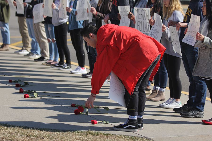 As he lays down the last rose, junior Dominic Martinez honors the 17th victim of the Parkland shooting.