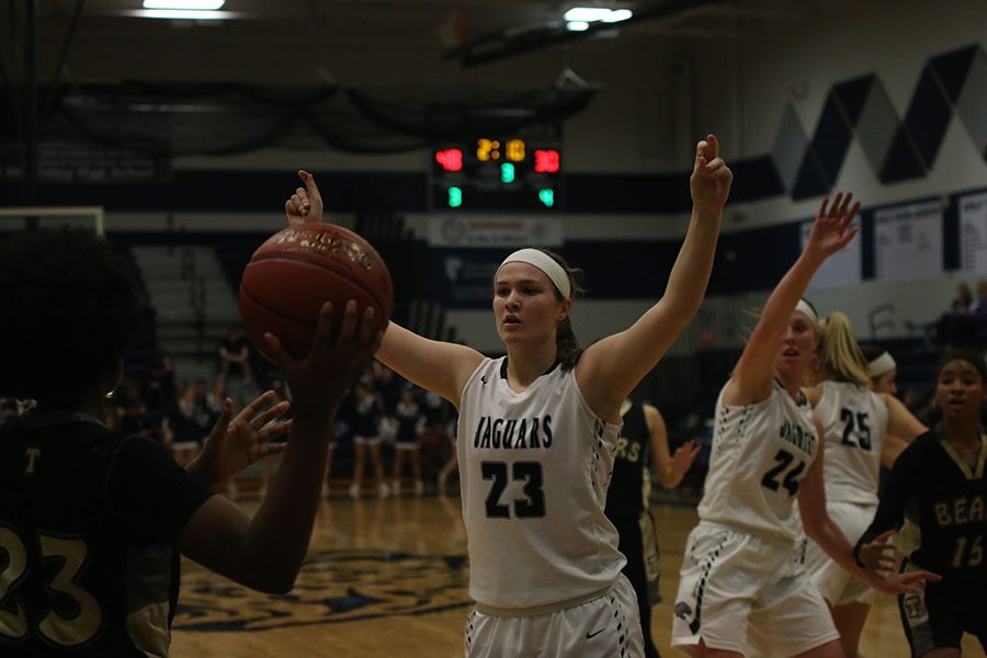 With arms in the air, junior Claire Kaifes blocks her opponent from passing the ball on Wednesday, Feb 28. The girls won 57-39 against Turner High School. 