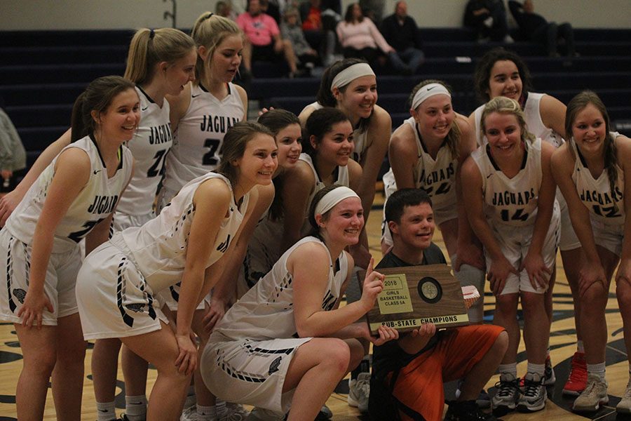 After winning the sub-state championship, the team poses for a photo with junior Matt Santaularia on Saturday, March 3. The girls team won against BVSouthwest 43-24. 