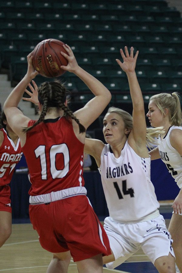 Lunging forward, senior Adde Hinkle attempts to block her opponent.