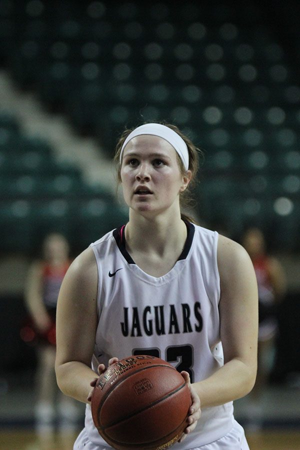 Focusing on the net, junior Claire Kaifes shoots a free throw.
