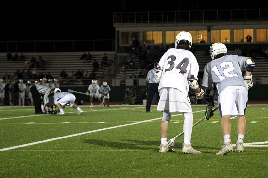 Before the match gets back in session, junior Kamren Lovett covers an opposing team member.