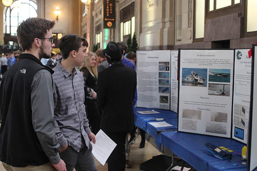 Juniors Johannes Seaberger and Kaden Beck view the project of a student from another school.