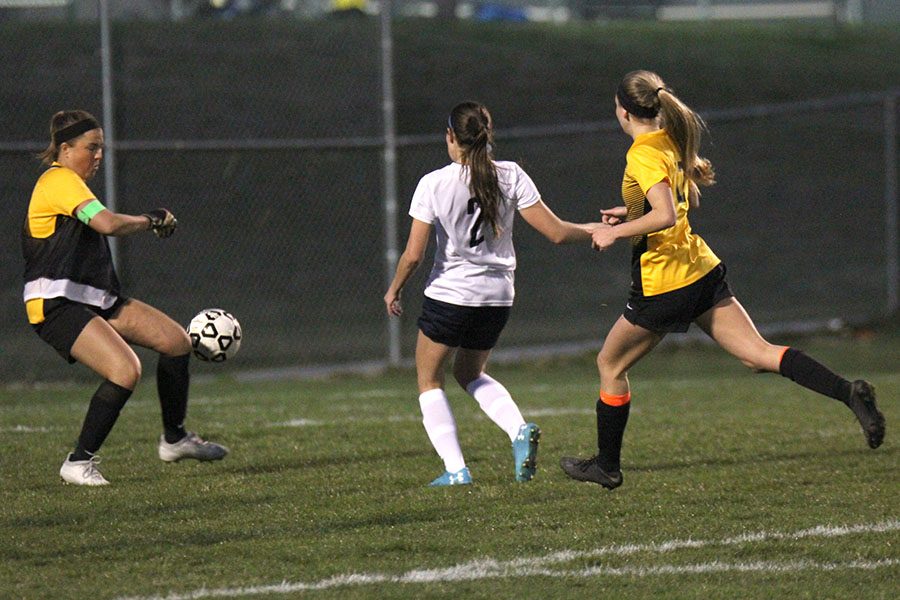 Running by her defender, freshman Peyton Wagoner shoots the ball past the opposing goalie for Mill Valleys fourth goal.