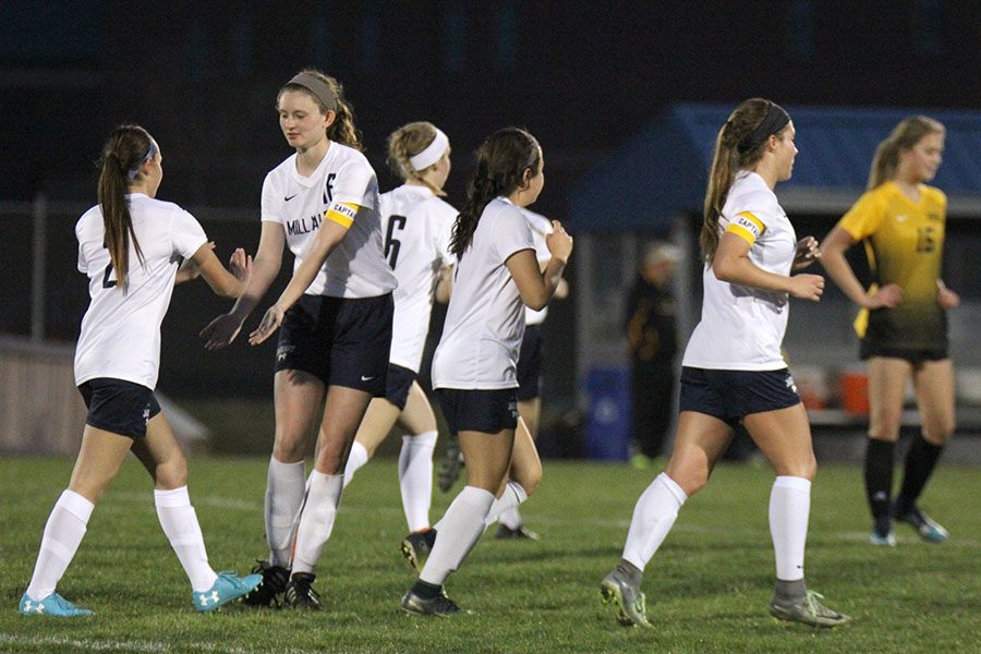 After scoring in the second half, freshman Peyton Wagoner celebrates with teammates.