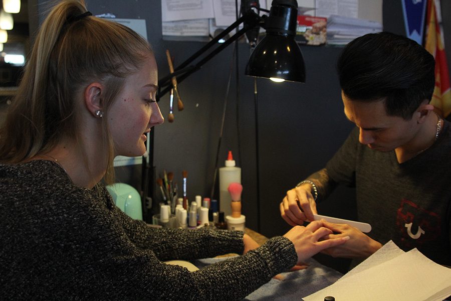 During a visit to Nail Art, sophomore Khloe Knernschield has her nails filed before they are painted on Wednesday, March 21. “I usually change the color every time, and I request the same person,” Knernschield said.