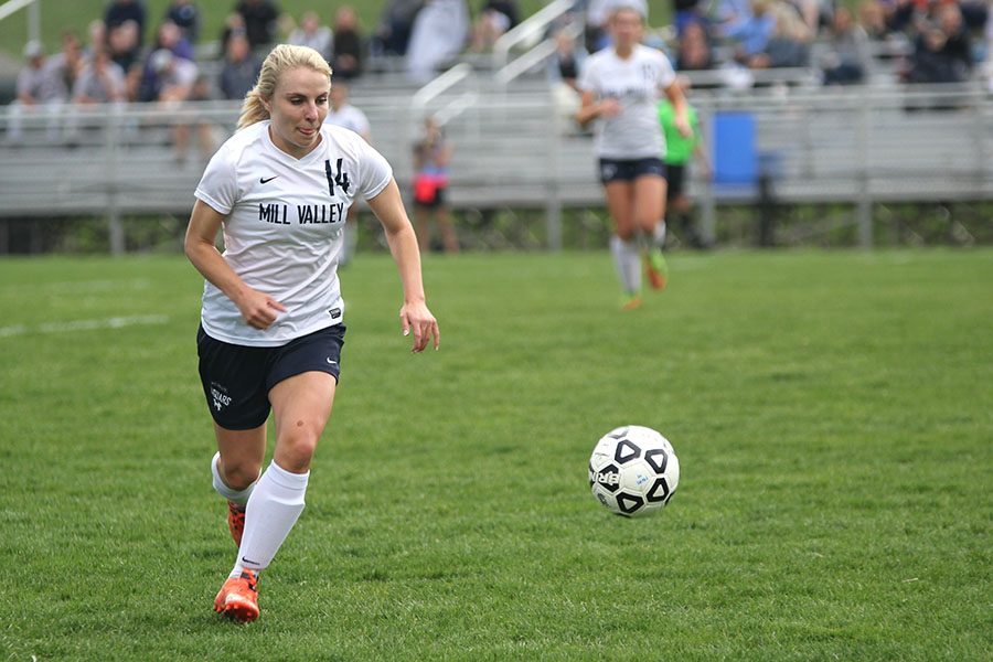 Attempting to secure the ball, senior Adde Hinkle runs to receive the ball.